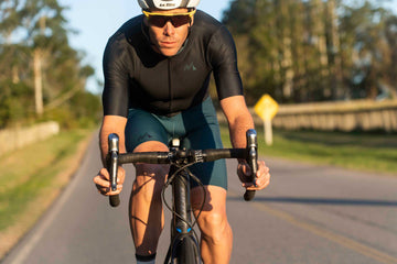frontal view of man cycling in mna metsa cycling jersey