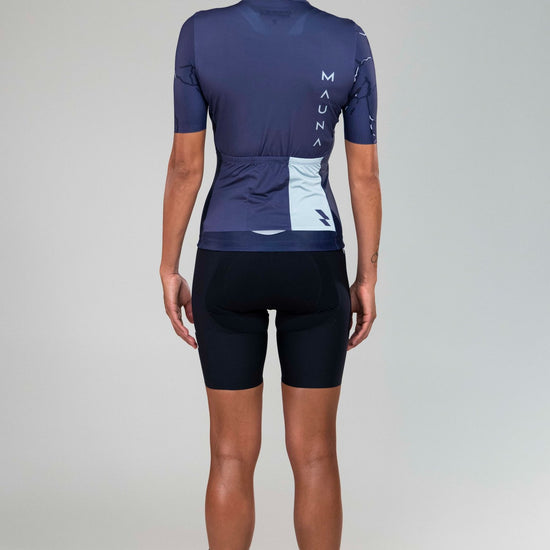 back full body view of woman wearing Eldhraun force cycling jersey