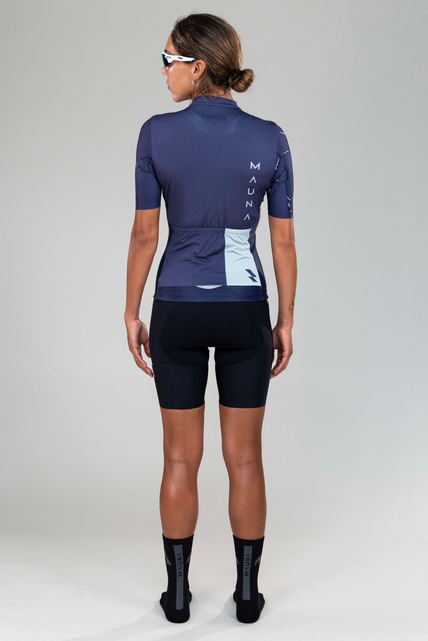 back full body view of woman wearing Eldhraun force cycling jersey
