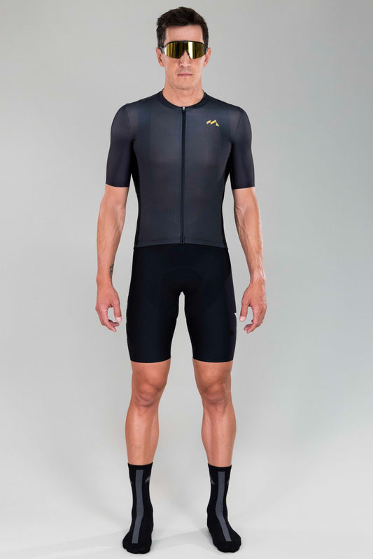 frontal full body view of man wearing Eldhraun force cycling jersey in black