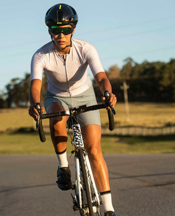 woman cycling wearing mna metsa training collection