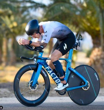 Man wearing a Mauna suit actively cycling