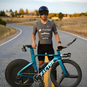 Sergio Gaytan standing by bicycle wearing Mauna Apparel